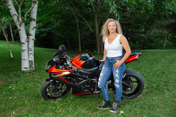 Fototapeta na wymiar Blonde woman with motocycle