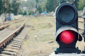 Red traffic light at a railway station.