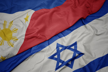waving colorful flag of israel and national flag of philippines.