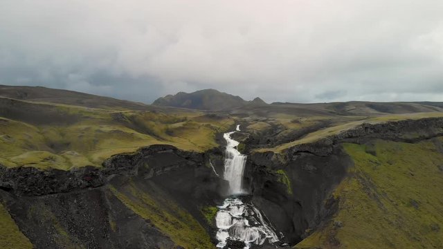 Ofaerufoss waterfall in Icelandic highlands overcast day, aerial pull away