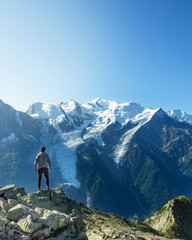 Fototapeta premium Man posing in front of Montblanc in the French Alps in Chamonix during a summer holiday trip. freedom and sport. Mountain and nature.