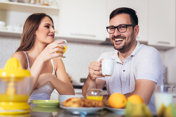 Obraz na płótnie Canvas Happy couple enjoying breakfast time together at home.
