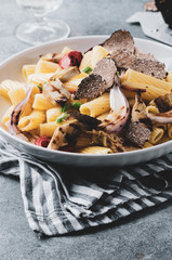 Tortiglioni with artichokes, black truffle and caramelized onion.