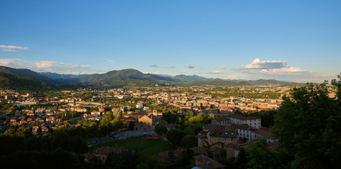 Obraz premium Bergamo with Alps mountains and blue cloudy sky