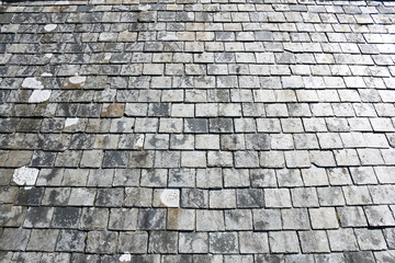 Square grey slate tiles from an English church roof. Square tiles from a roof of a church in Cornwall, England.