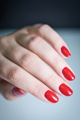 Female hand with a beautiful red manicure