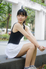 Obraz na płótnie Canvas Portrait of thai adult beautiful girl black shirt white skirt relax time