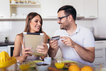 Couple buying online on the interent with a credit card.