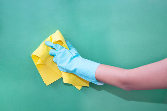 doing cleaning with green rubber gloves