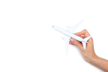 Airplane model in female hand on white background