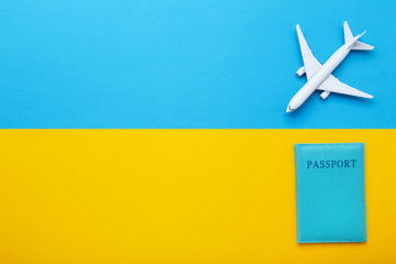 Airplane model with passport on colorful paper background