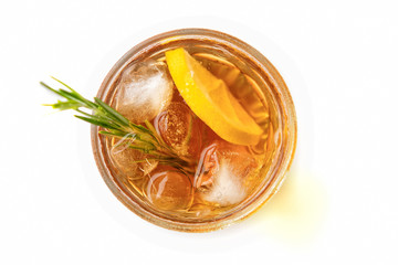 glass of lemonade or cocktail with lemon and ice top view