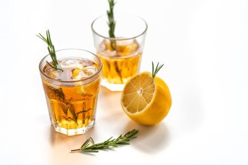 glasses of soda with lemon and rosemary on a light background