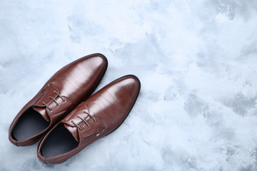 Male leather shoes on grey background