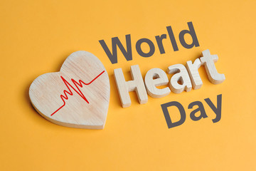 World Heart Day Concept. Shape Heart symbol and heart text created off wood