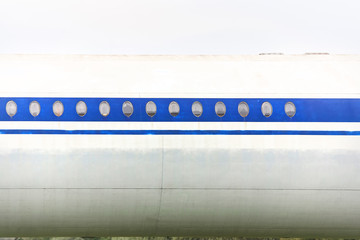 Elements of a passenger plane with a blue stripe closeup.