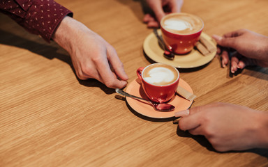 Faceless barista giving finished coffee