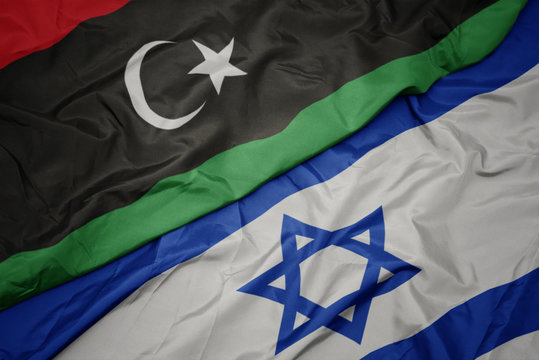 waving colorful flag of israel and national flag of libya.