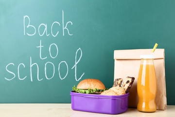 School lunch with paper bag on chalkboard background