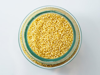 Dried raw millet on the white background