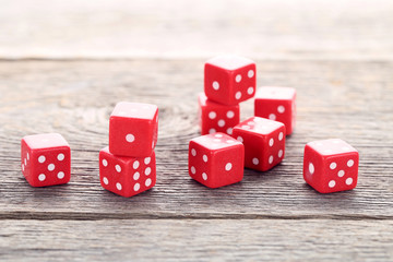 Red dice on grey wooden table