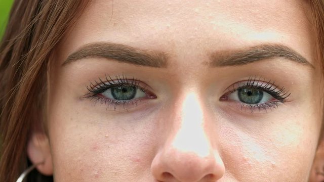 Close up shot of a young woman's piercing green eyes