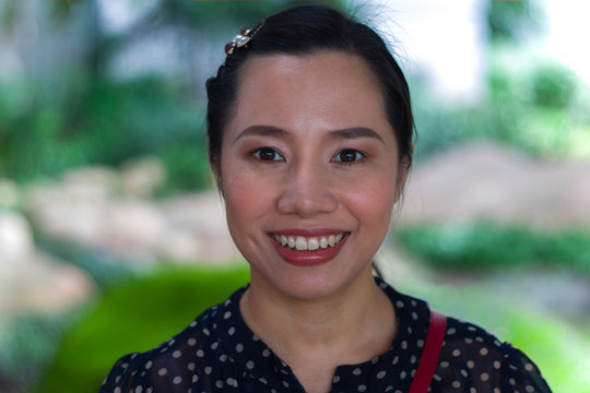 Portrait of happy charming Thai woman and smiling for happy time