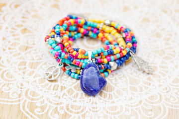 boho beads necklace or bracelet with sodalite mineral stone on decorative wooden background