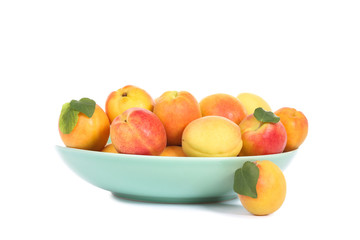 Sweet apricots in bowl isolated on white background