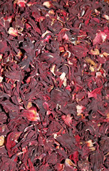 Heap of red herbal tea. Dried petals of hibiscus. Top view