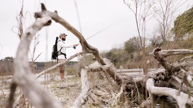 Fly Fisher Hikes And Fishes A Limestone Riverbed On The Medina River In The Texas Hill Country.