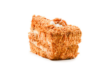 Peace of honey cake isolated on white background.