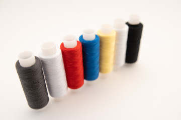 Set of sewing threads beautiful color (blue,yellow, green, white, black) on white background with space for text