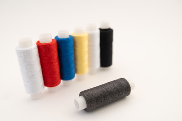 Set of sewing threads beautiful color (blue,yellow, green, white, black) on white background with space for text