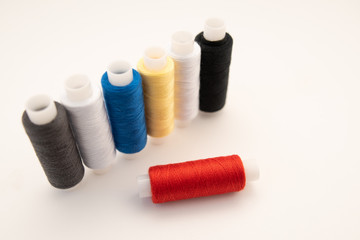 Set of sewing threads beautiful color (blue,yellow, green, white, black) on white background with space for text