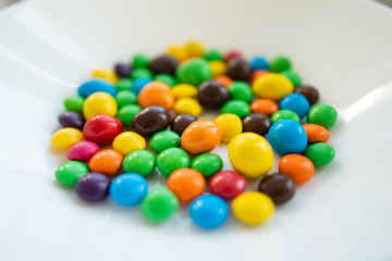 multicolored candies on a white plate