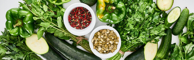 panoramic shot of pumpkin seeds, spices, peppers, greenery, cucumbers and zucchini