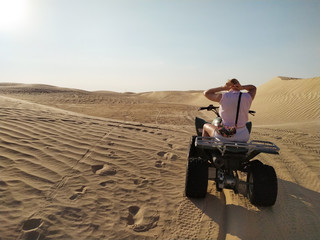 Woman Is Riding a Quad Bike in the Desert Sahara