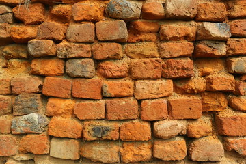 Old orange and red breakable brick arch wall with pattern.