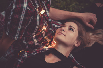 A young couple of lovers missed the train. Playing song with guitar on the rails in the autumn...