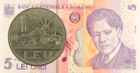 1 romanian leu coin against 5 romanian leu banknote indicating growing economics with copyspace