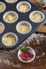 Delicious flavored cupcake with raspberries, white cream, and chocolate icing.