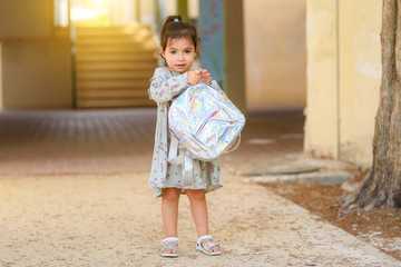 Happy kid back to school. Little girl with backpack go to elementary school. Child of primary school. Portrait of pupil going to school for the first time.