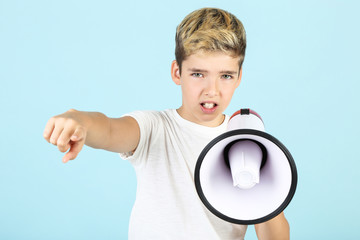 Young boy with megaphone on blue background