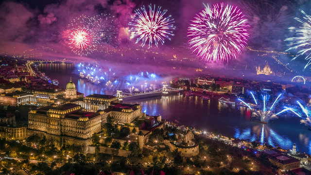 Budapest, Hungary - Aerial panoramic view of Budapest with illuminated Buda Castle Royal Palace, St.Stephen's Basilica and Szechenyi Chain Bridge by night with fireworks