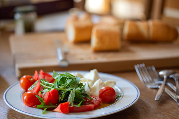 Cherry tomatoes with rucola leaves and pieces of mozarella cheese