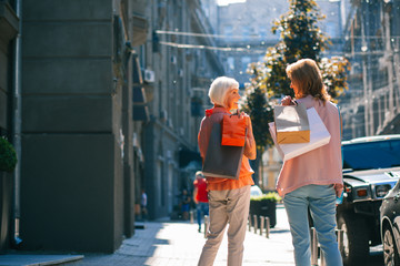Fototapeta premium Happy women enjoying walking after shopping stock photo