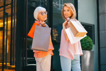 Gladsome women with purchases after shopping stock photo