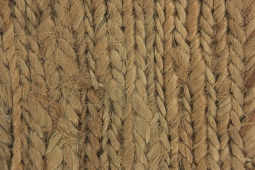 light brown natural woven beach seagrass fibers close up texture with flat neutral lighting