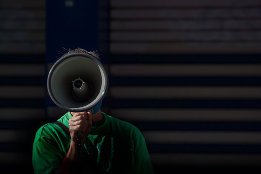 Megaphone covering the face of a protesters shouting